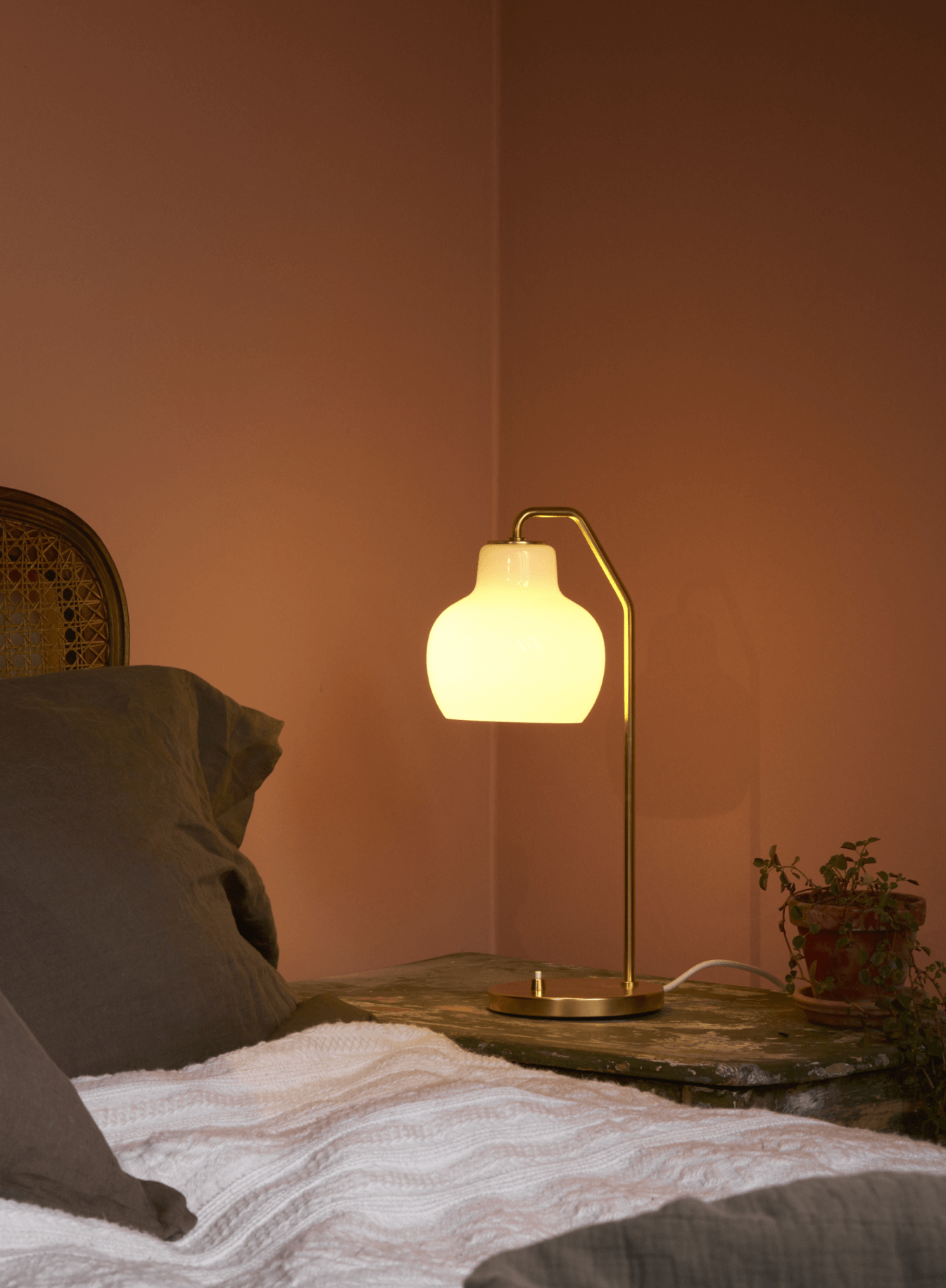 VL Ring Crown table lamp on bedside table with warm glow, © 2025 Louis Poulsen.